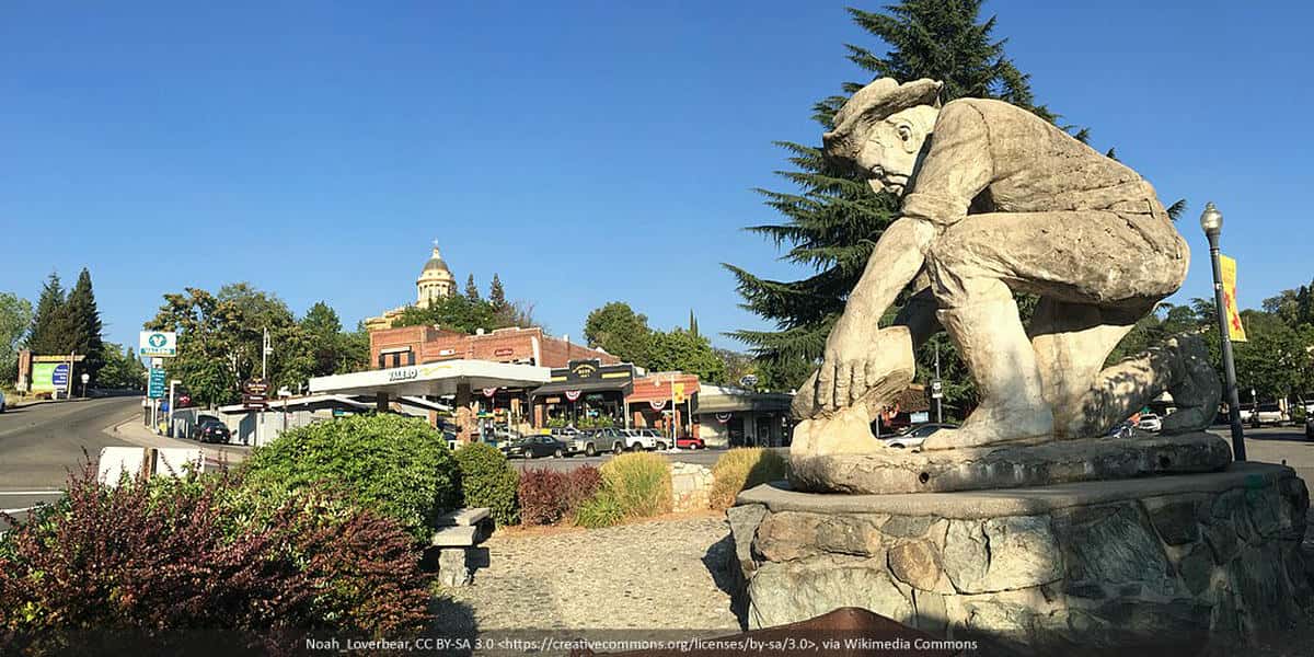 Downtown Auburn, California panorama with gold-panning statue featured.